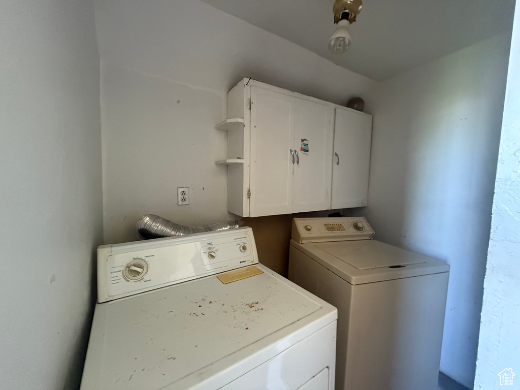 Laundry room featuring cabinet space and washer and dryer
