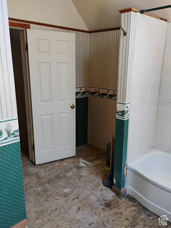 Full bath featuring lofted ceiling and bathing tub / shower combination