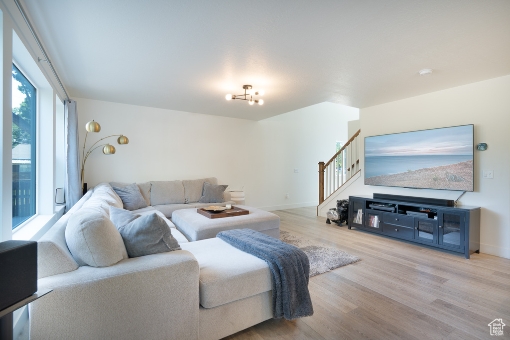 Living room with light wood-type flooring and stairway
