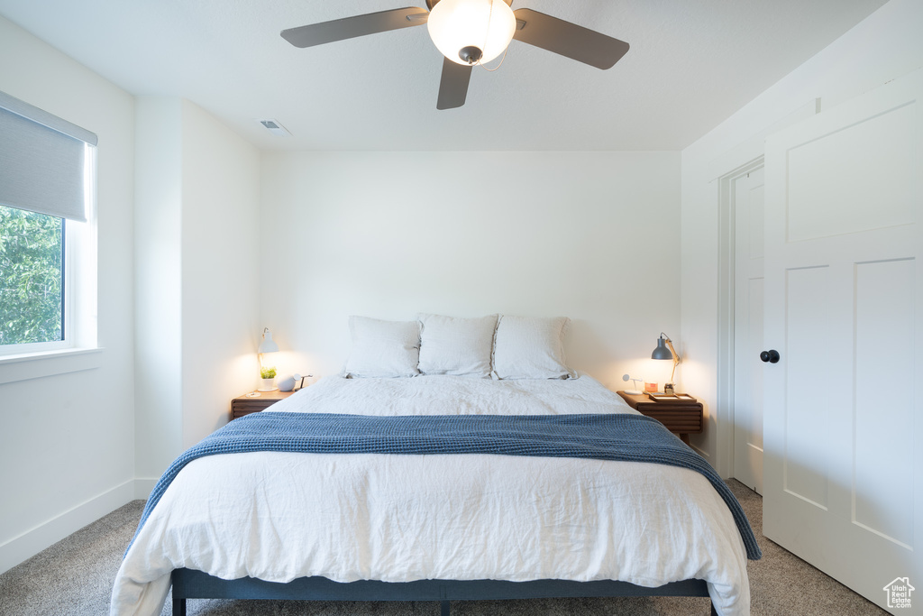 Bedroom with carpet floors and a ceiling fan