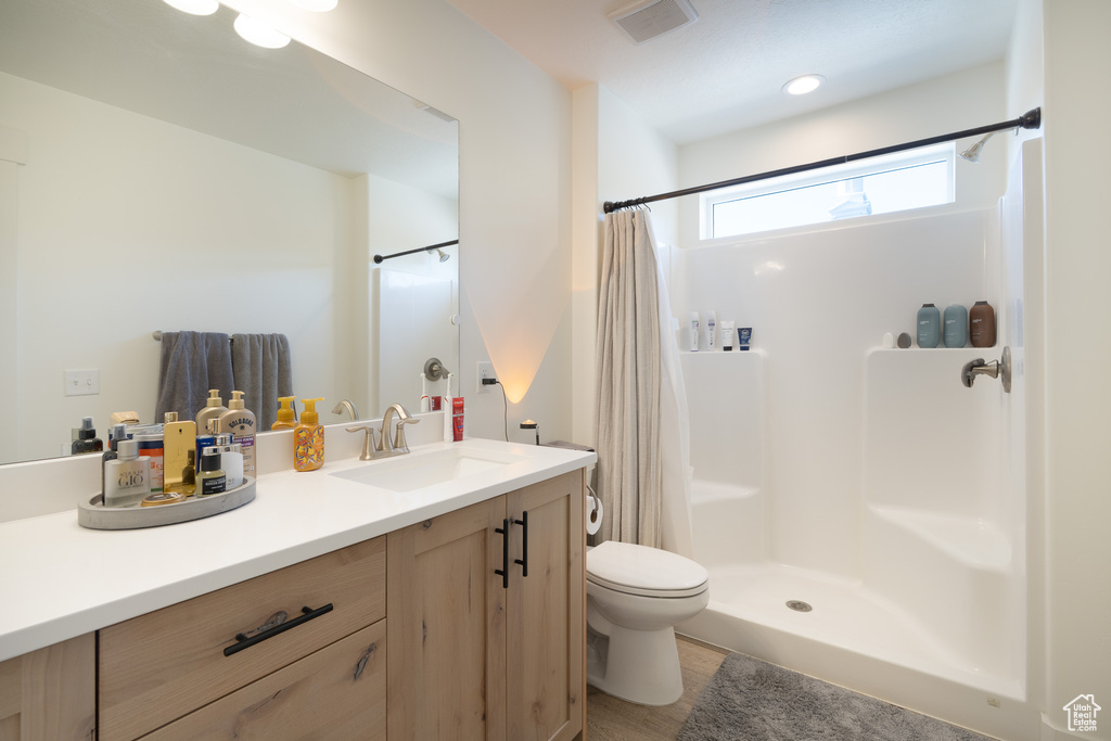 Full bathroom with vanity and a shower with shower curtain