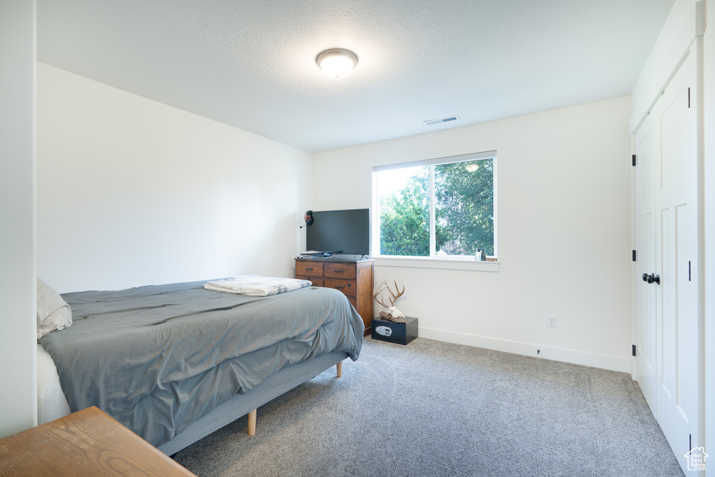 Bedroom with carpet flooring and baseboards
