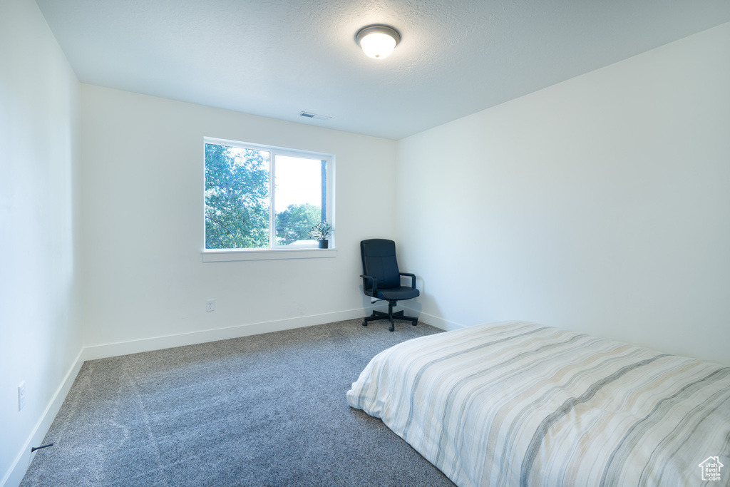 Carpeted bedroom featuring baseboards