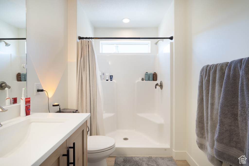Bathroom featuring a shower with curtain and vanity