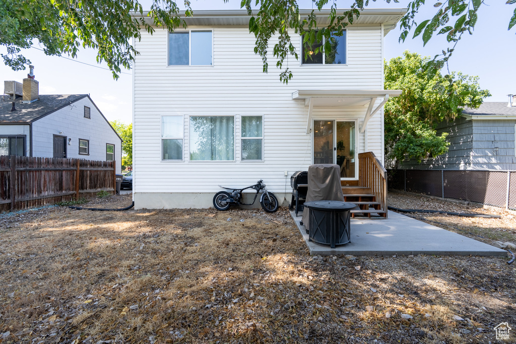 Back of property with a patio