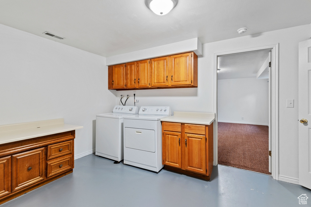 Laundry room with cabinet space and washer and dryer