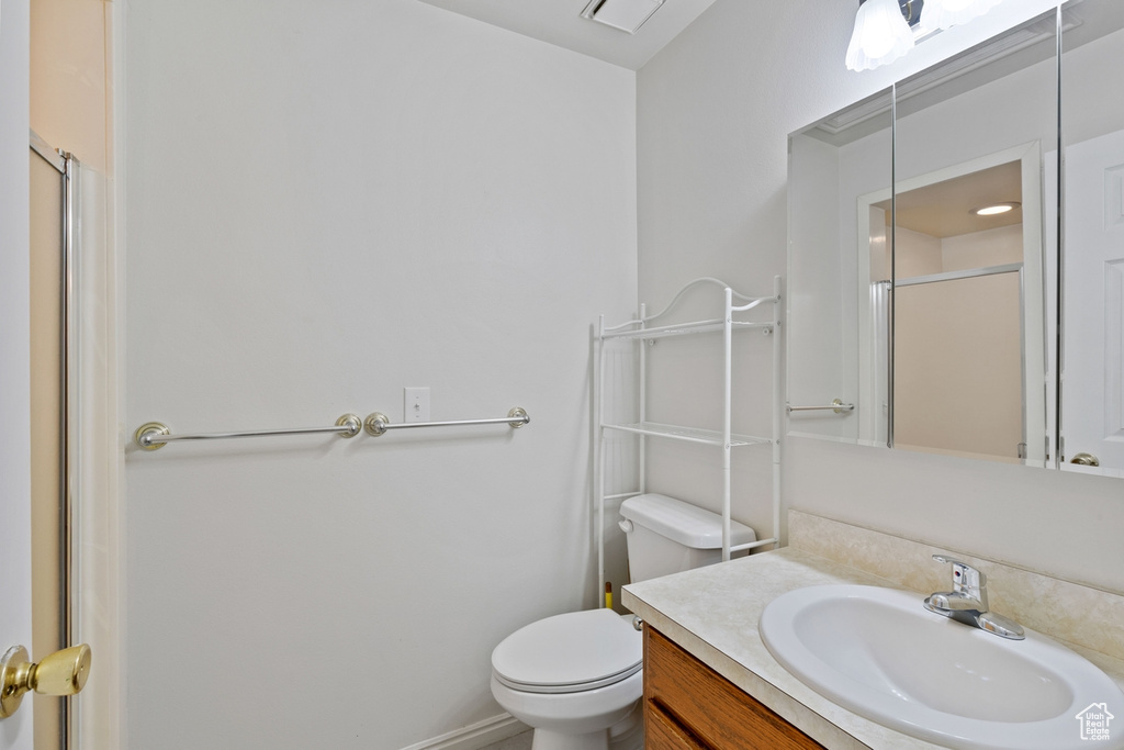 Full bathroom featuring vanity and a shower with door