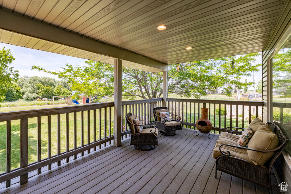Deck with a playground and a lawn