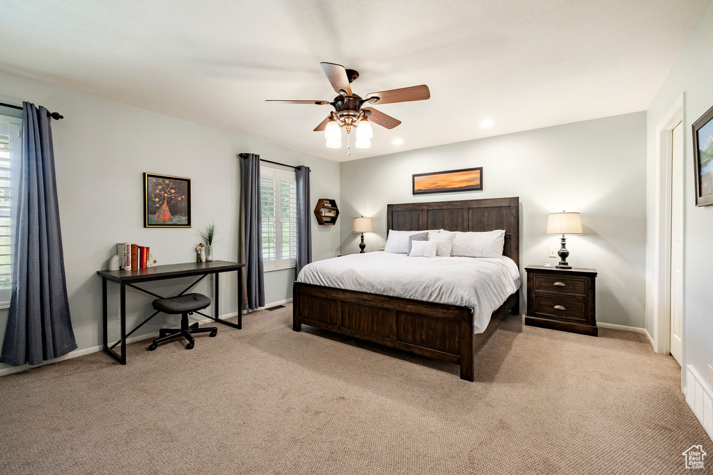 Bedroom with light carpet, a ceiling fan, and recessed lighting