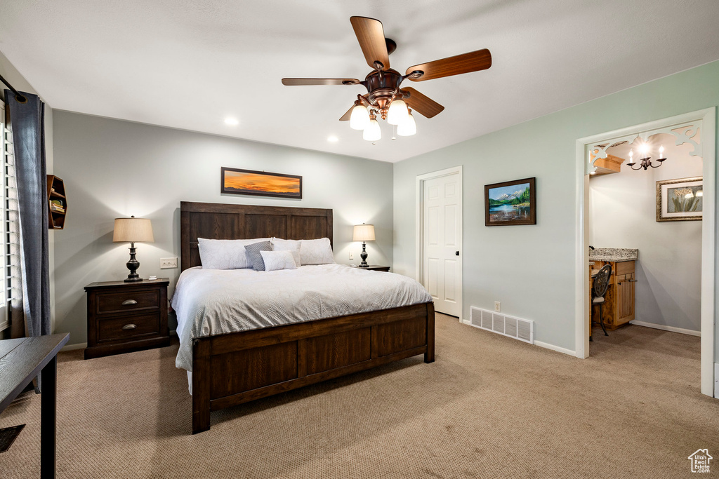 Bedroom featuring carpet flooring, a ceiling fan, ensuite bathroom, a chandelier, and recessed lighting