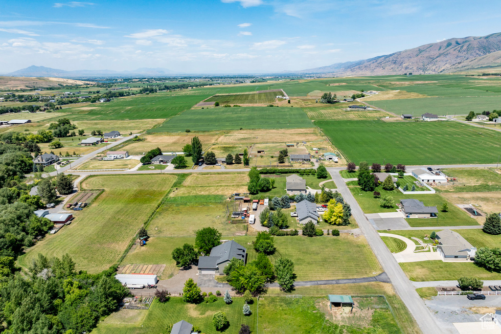 Overview of rural landscape featuring rows of crops and mountains