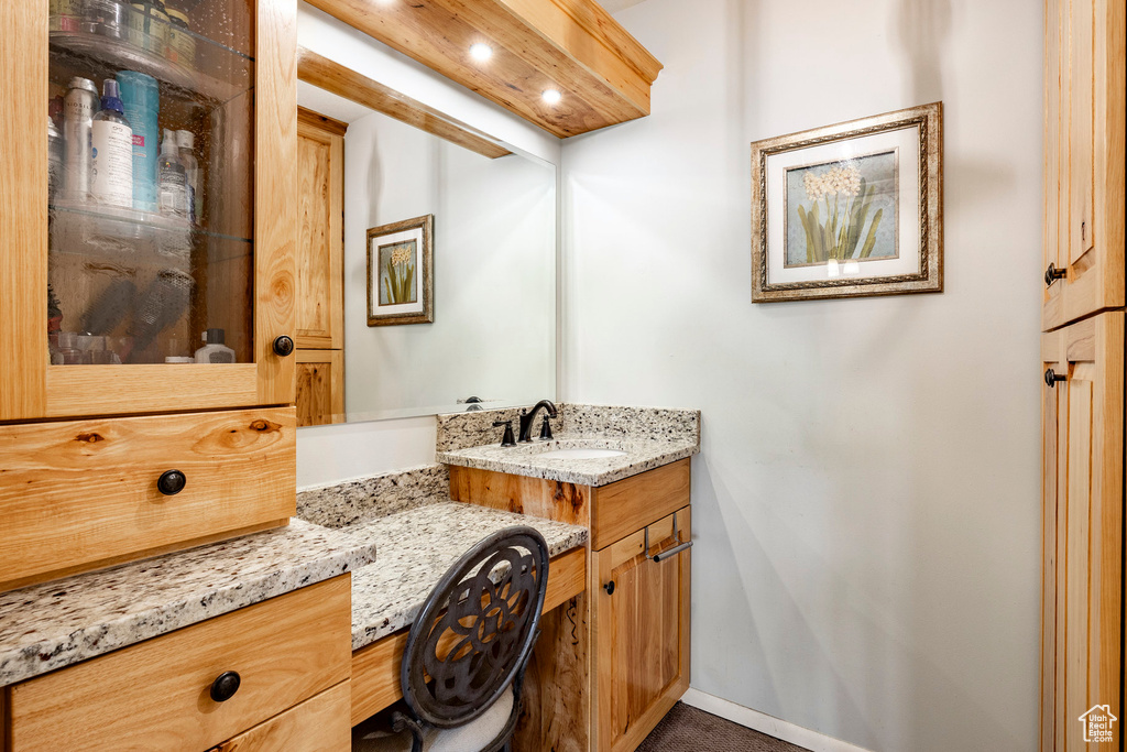 Bathroom with vanity and recessed lighting