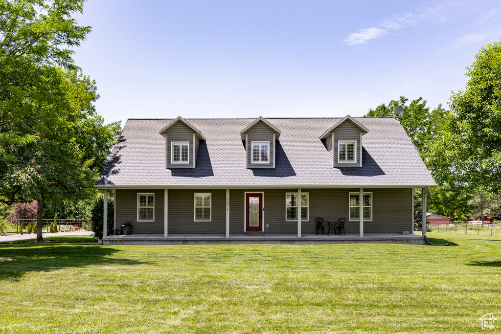 View of front of house featuring covered porch and roof with shingles