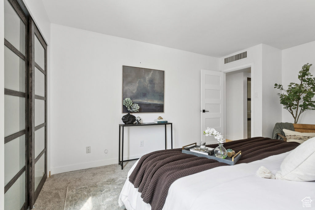 Bedroom featuring light carpet and baseboards