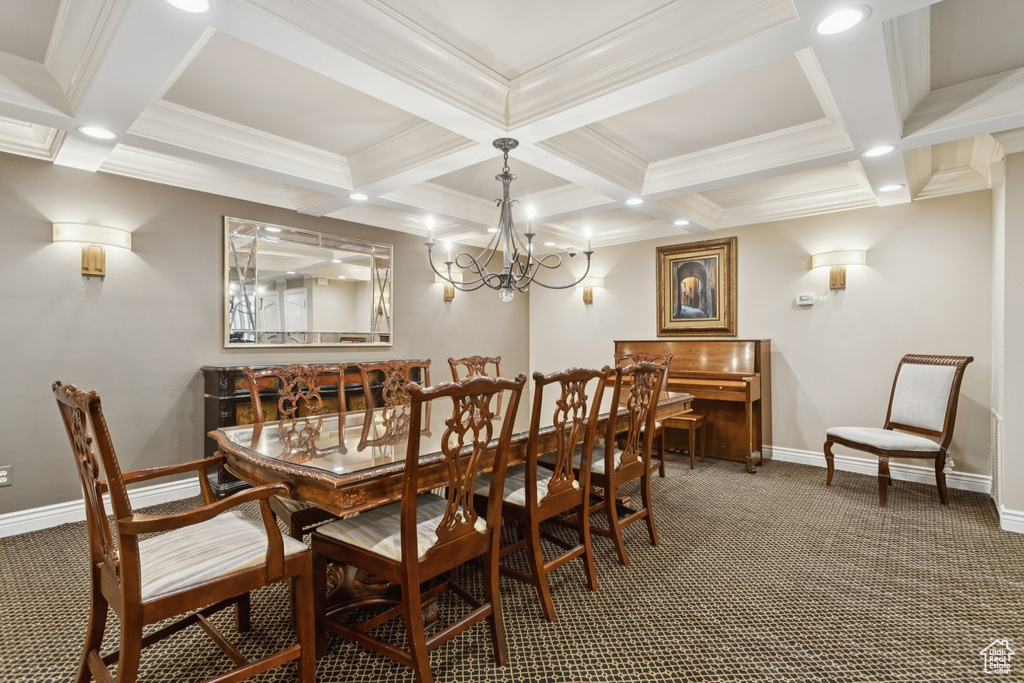 Dining room with carpet flooring, coffered ceiling, beamed ceiling, a chandelier, and crown molding