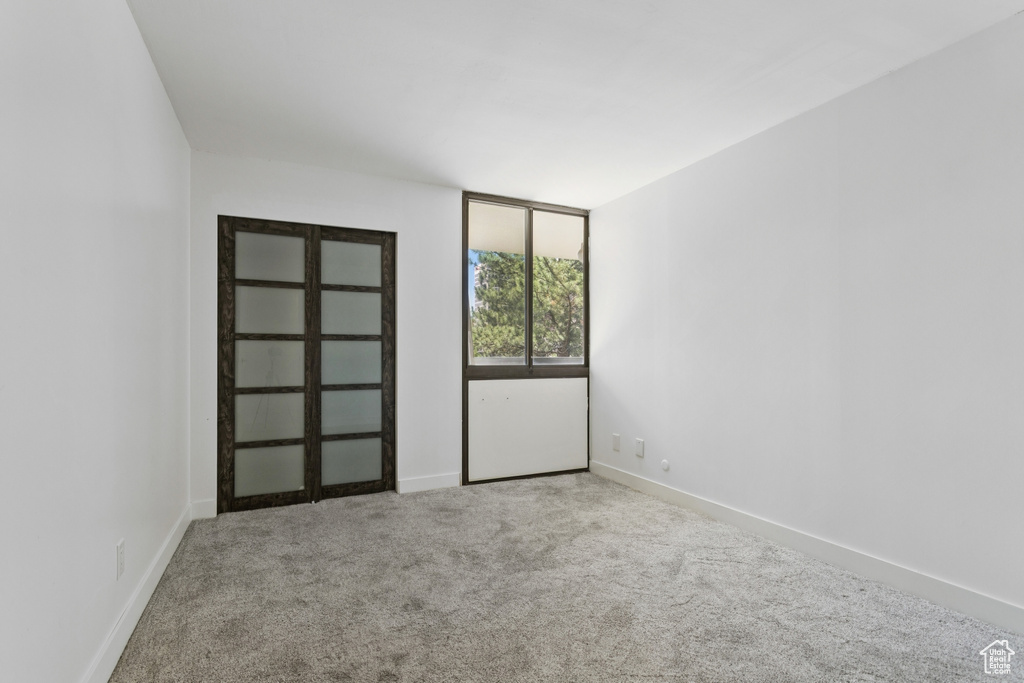 Carpeted spare room with baseboards