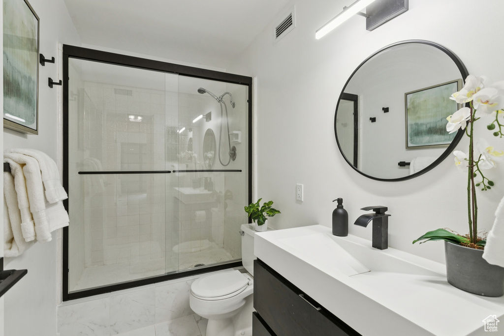 Full bath with vanity, a shower stall, and marble finish flooring