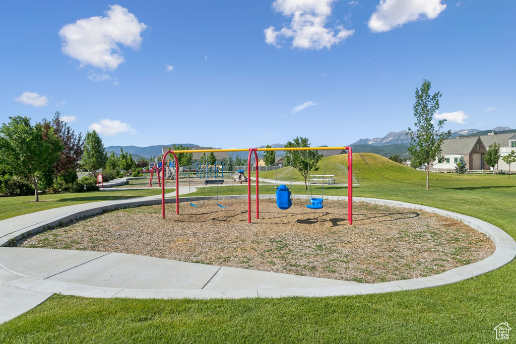 Community jungle gym with a lawn and a mountain view