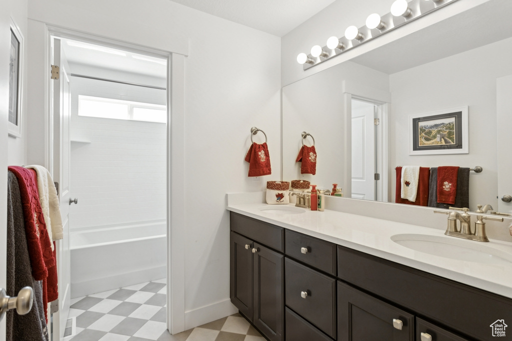 Full bathroom with tile patterned floors, double vanity, and tub / shower combination