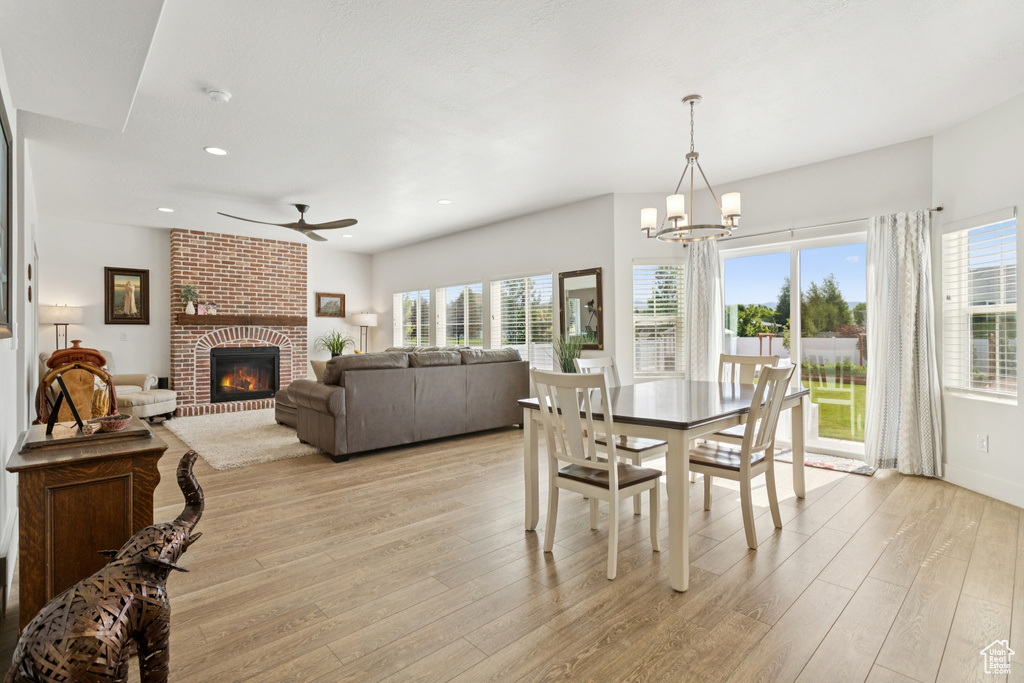 Dining space with a ceiling fan, light wood finished floors, healthy amount of natural light, and recessed lighting