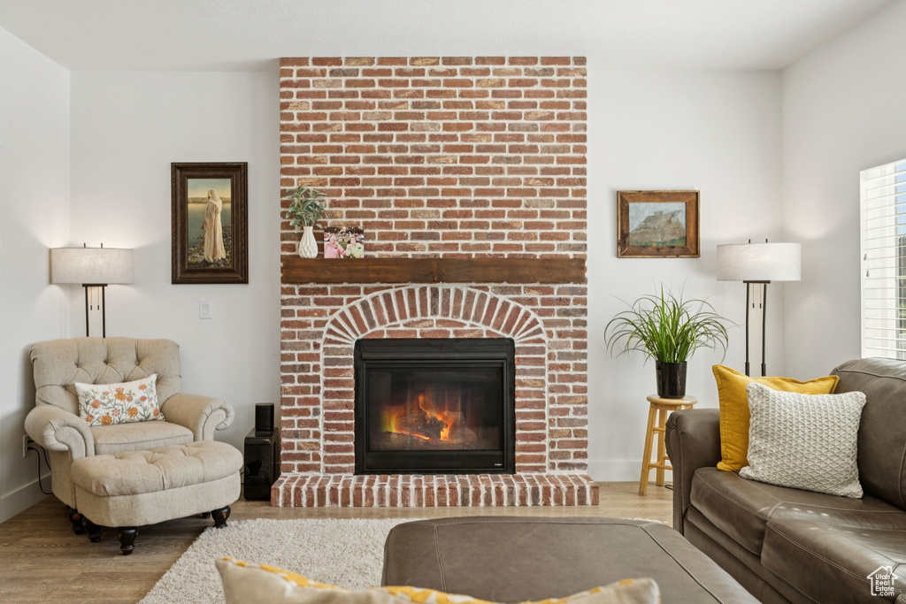 Living area featuring wood finished floors and a fireplace