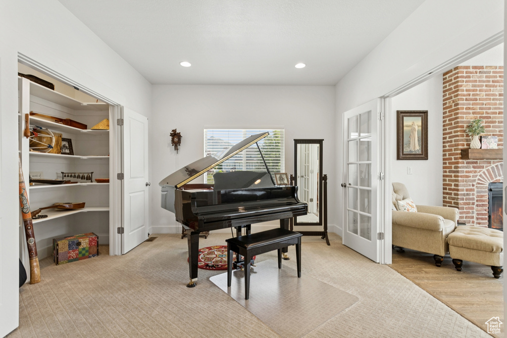 Living area featuring french doors, recessed lighting, and a fireplace