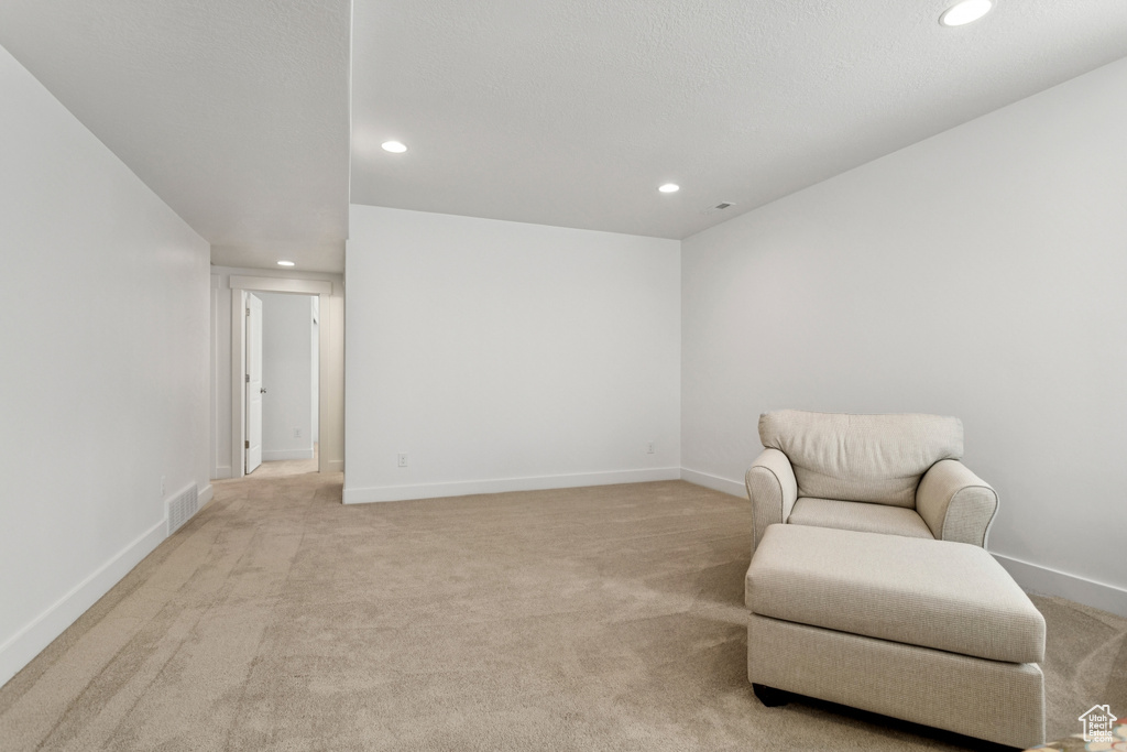 Sitting room featuring recessed lighting and light carpet