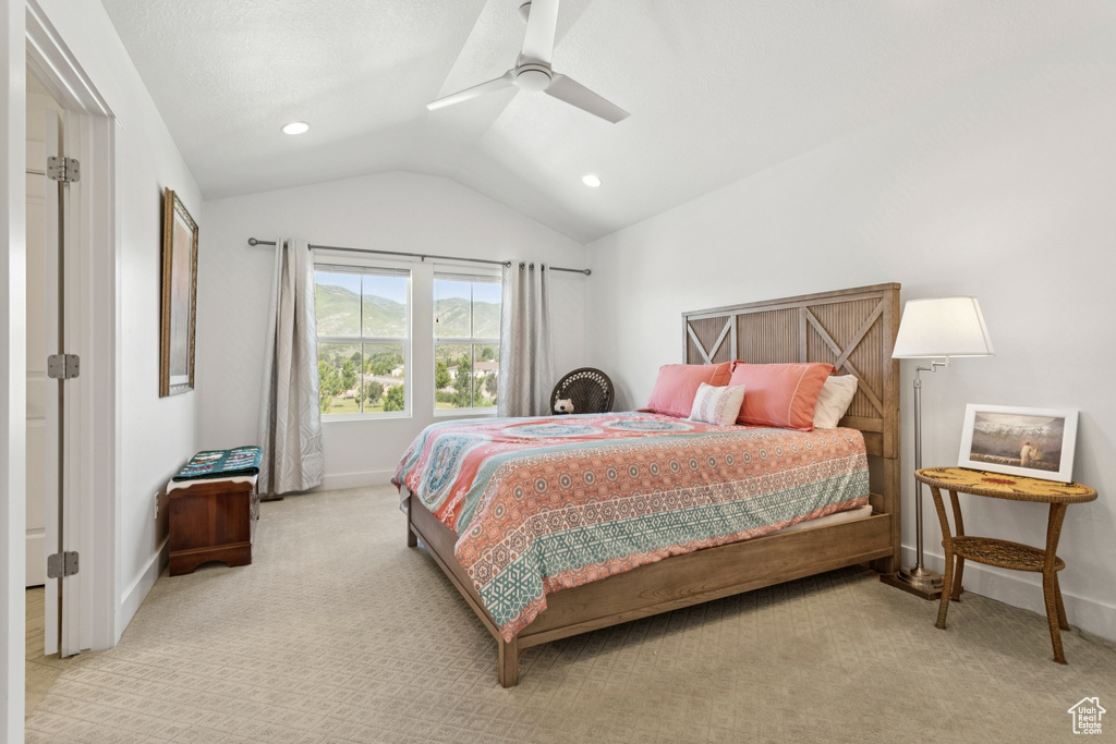 Bedroom with lofted ceiling, light colored carpet, a ceiling fan, and recessed lighting
