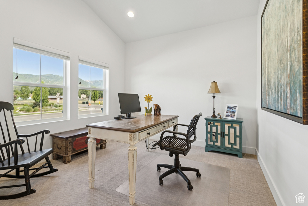 Office space with carpet floors, high vaulted ceiling, and recessed lighting