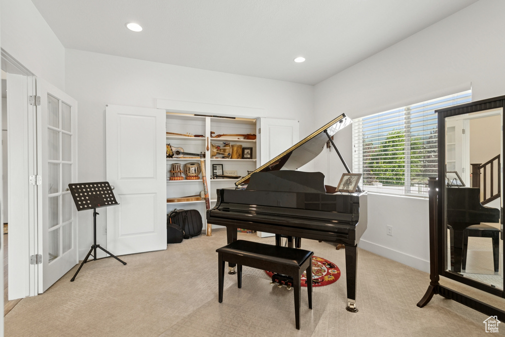 Sitting room with light carpet and recessed lighting