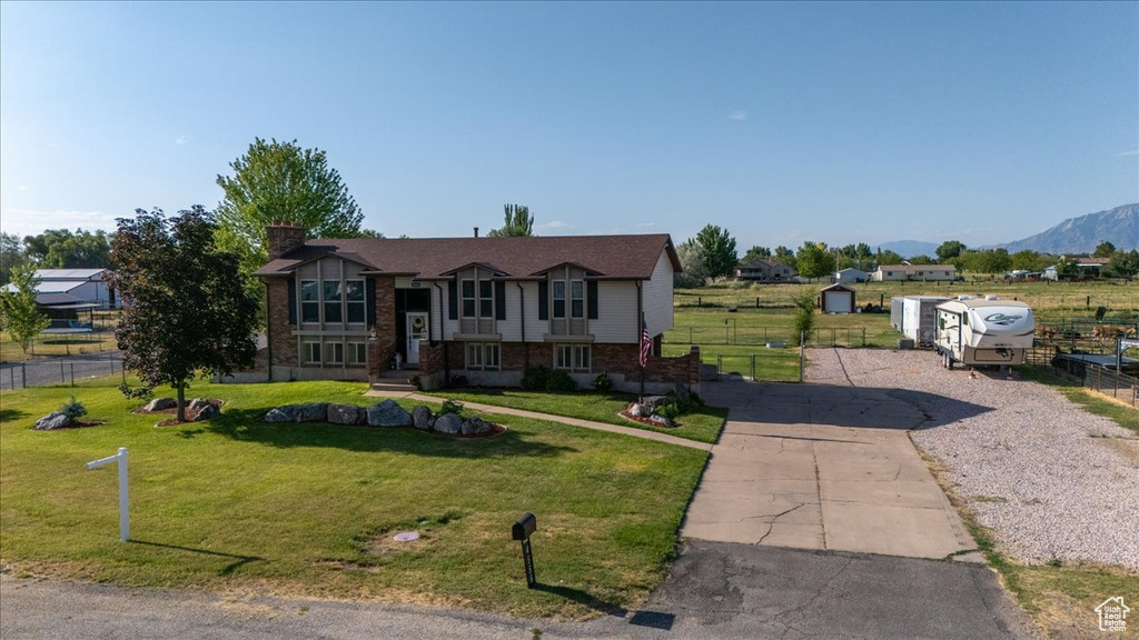 Split foyer home with a chimney and brick siding