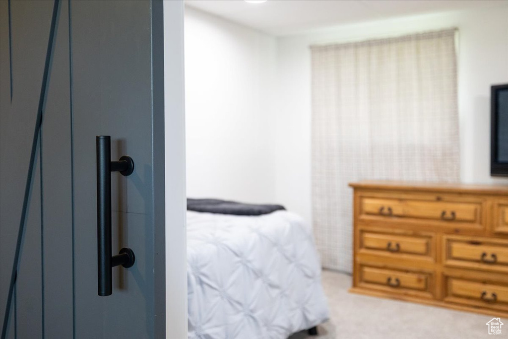 Bedroom featuring light colored carpet