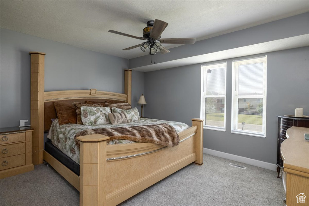 Bedroom featuring light colored carpet and a ceiling fan