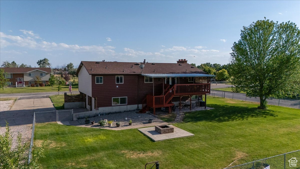 Back of house with a wooden deck, an outdoor fire pit, a patio area, and stairway
