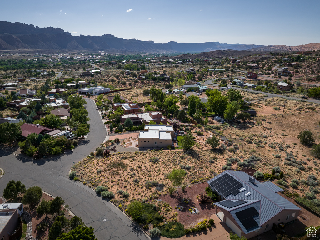 Aerial perspective of suburban area with a mountain backdrop and a desert landscape