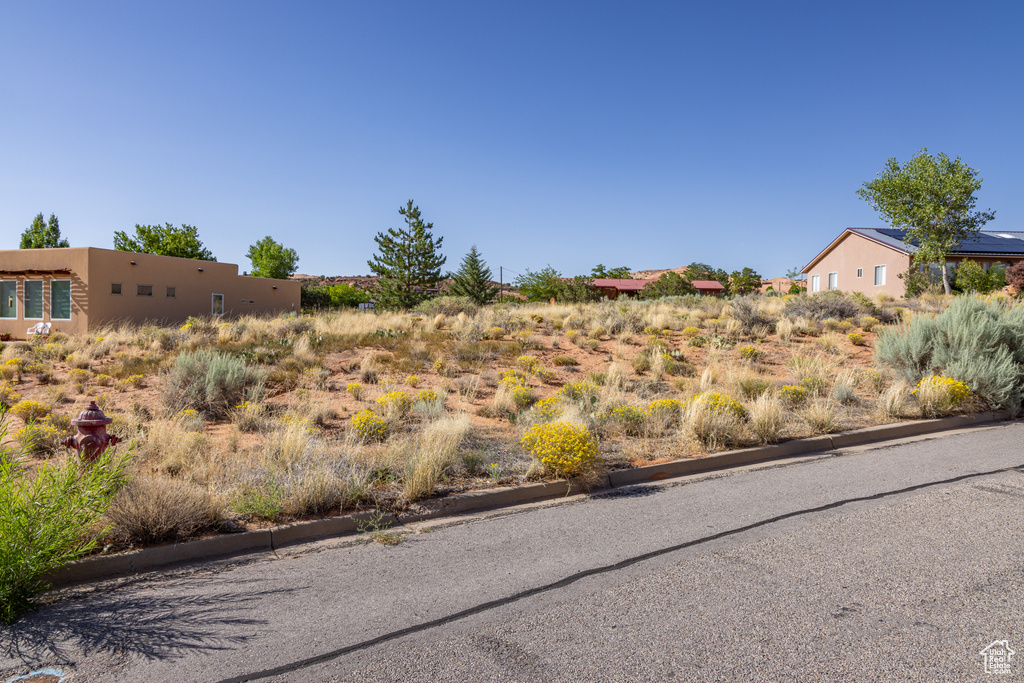 View of asphalt street featuring curbs