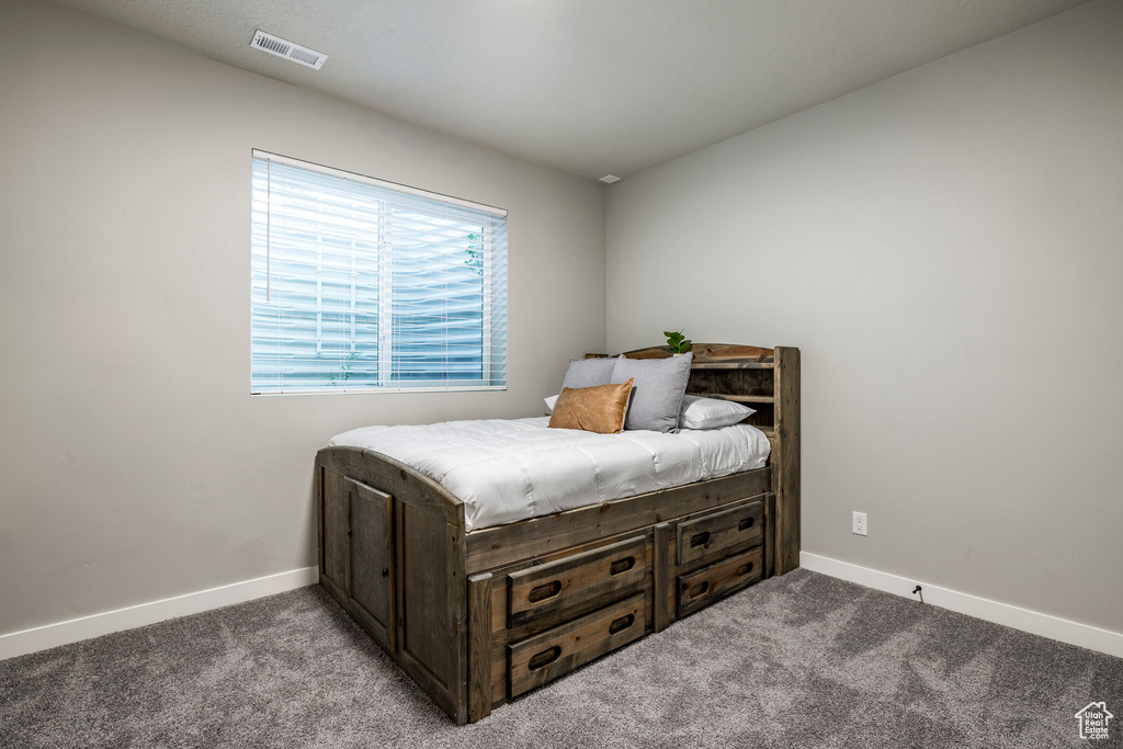 Bedroom with carpet floors and baseboards