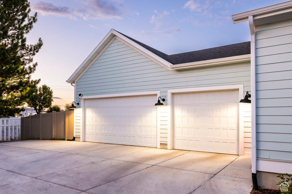 Garage featuring concrete driveway