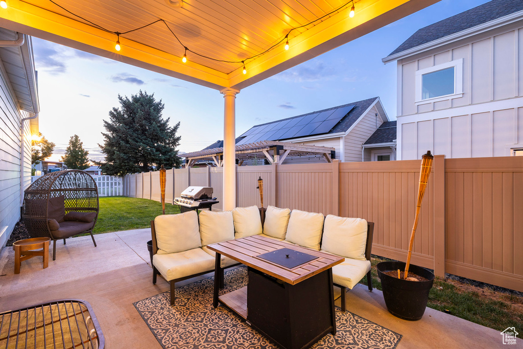 Fenced backyard with outdoor lounge area, a patio, and area for grilling