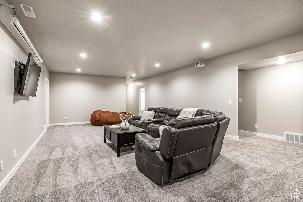 Home theater with light carpet and recessed lighting
