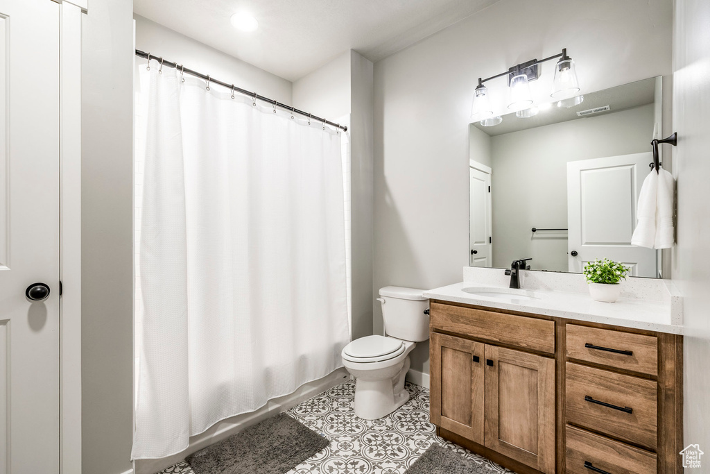 Full bath with vanity and tile patterned floors