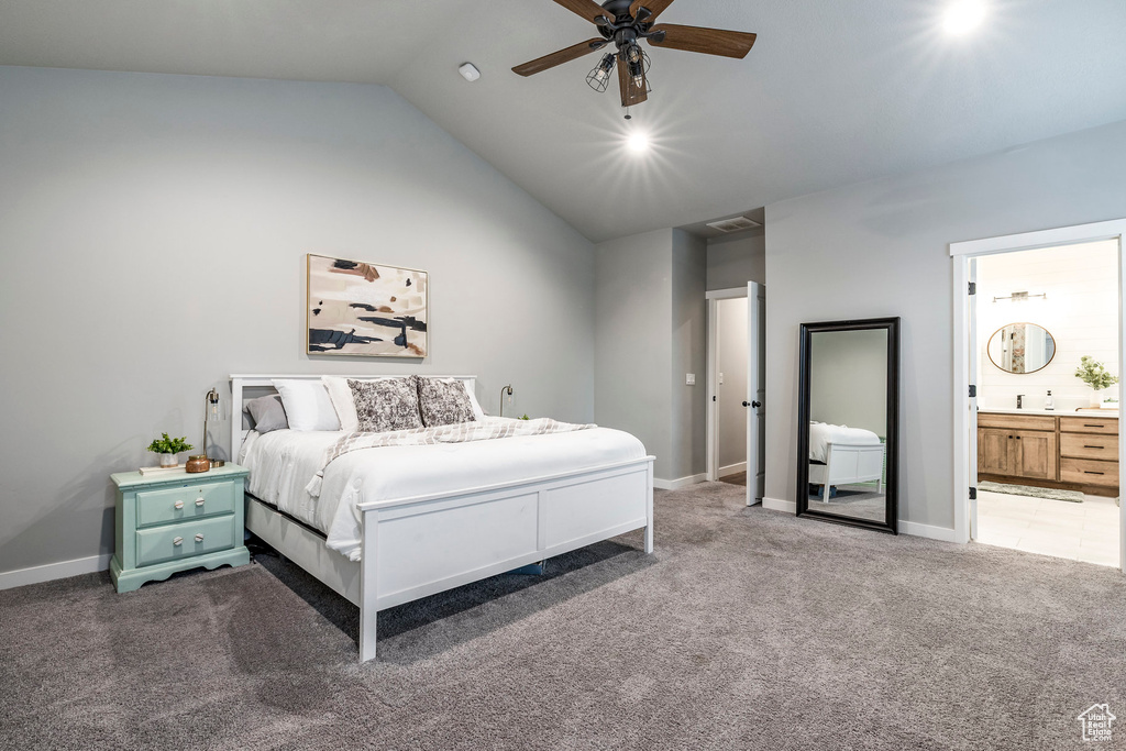 Bedroom featuring carpet, lofted ceiling, connected bathroom, and a ceiling fan