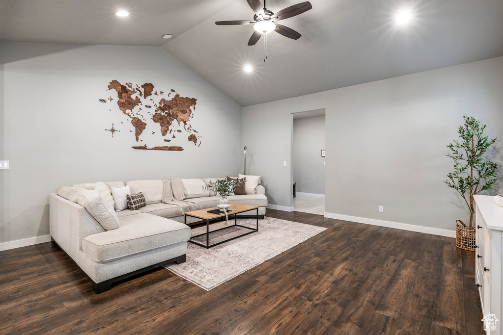 Living area with a ceiling fan, dark wood finished floors, vaulted ceiling, and recessed lighting