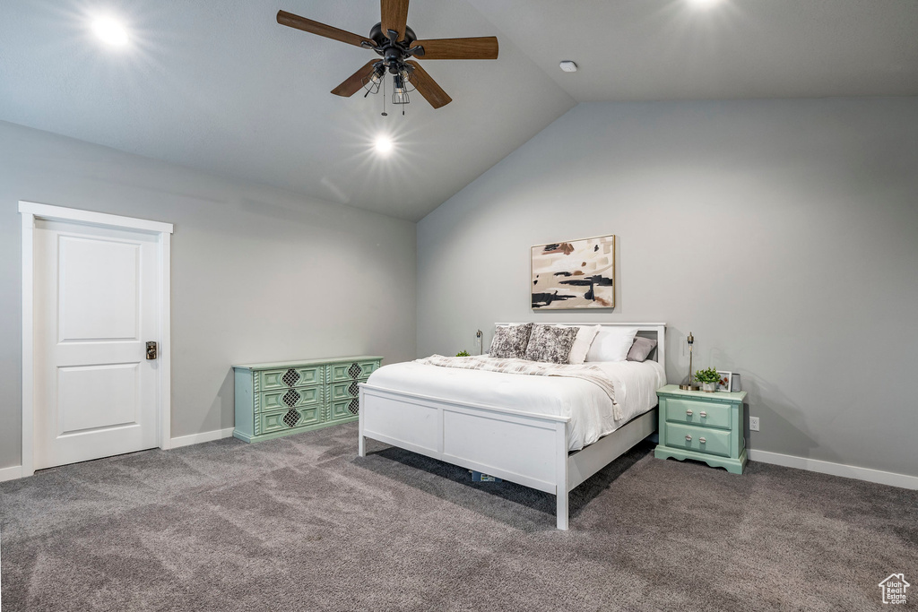 Bedroom with lofted ceiling, carpet flooring, and a ceiling fan