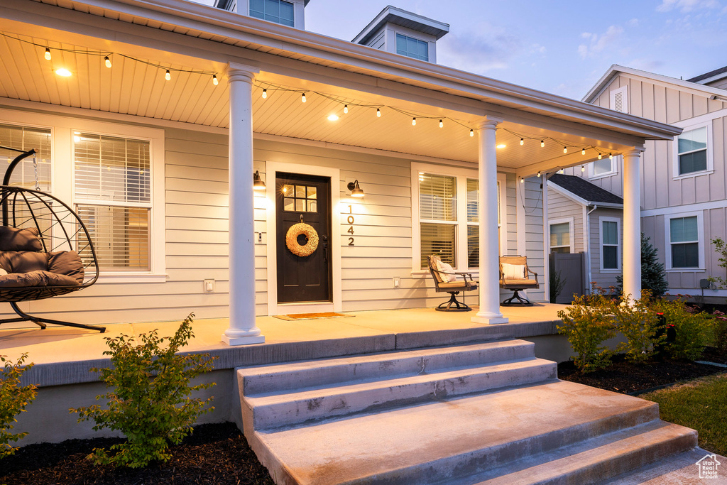 Property entrance featuring a porch and board and batten siding