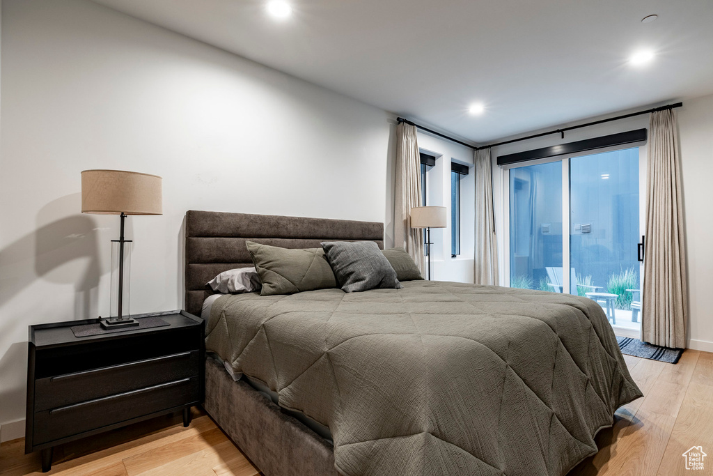 Bedroom featuring light wood-style flooring, access to exterior, and recessed lighting