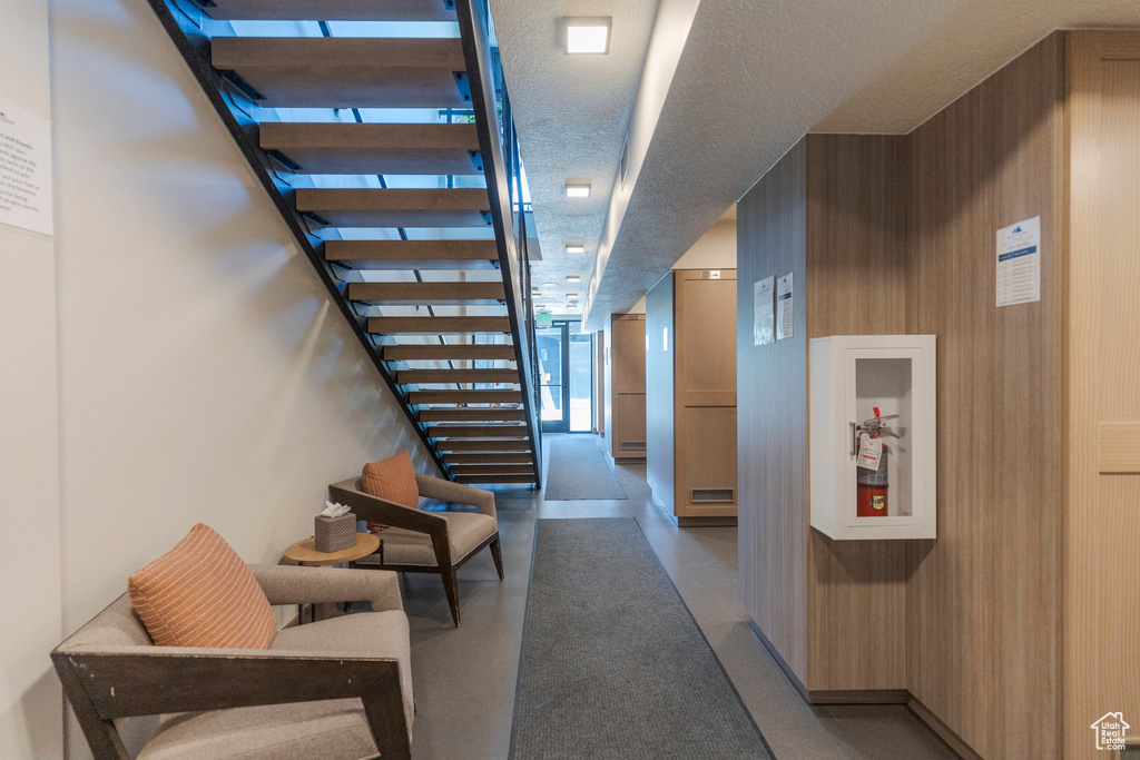Hall with stairway and a textured ceiling