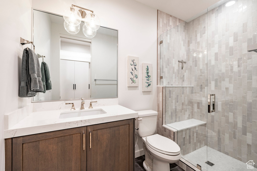 Full bathroom featuring vanity, a stall shower, and a chandelier