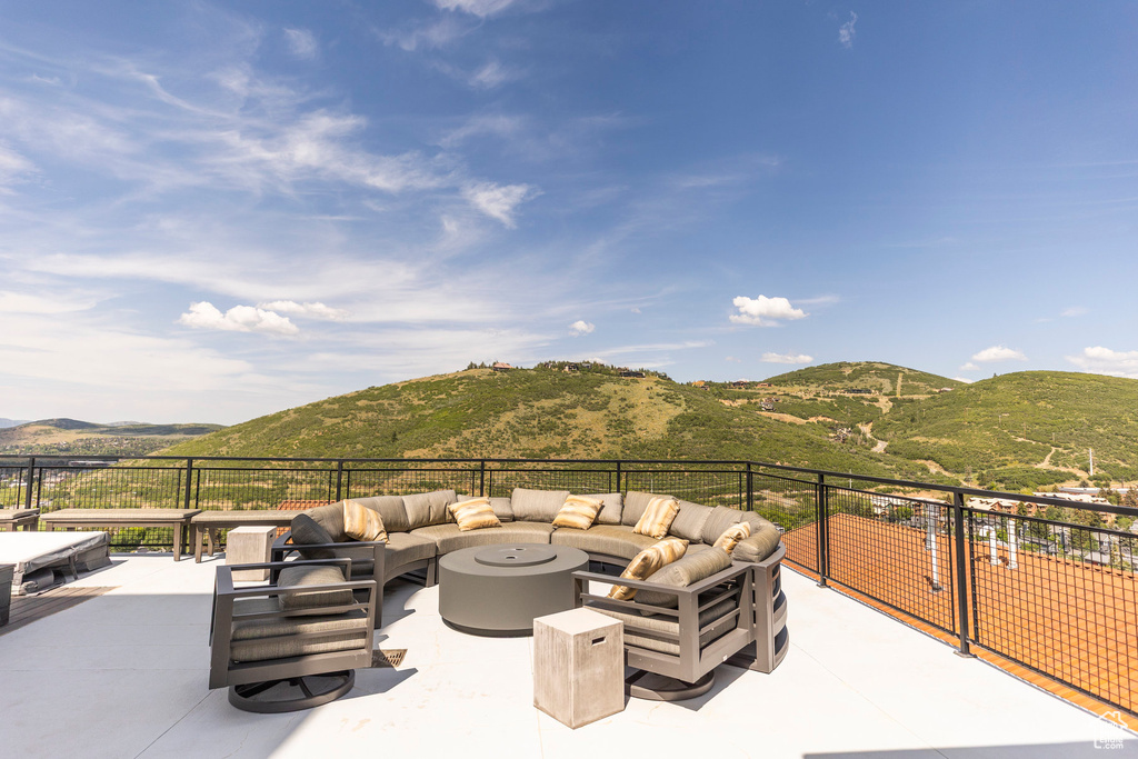 View of patio with an outdoor living space and a mountain view