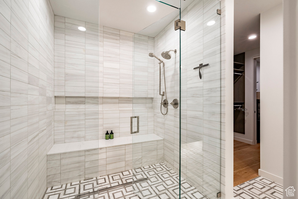 Bathroom with a shower stall, recessed lighting, and a walk in closet